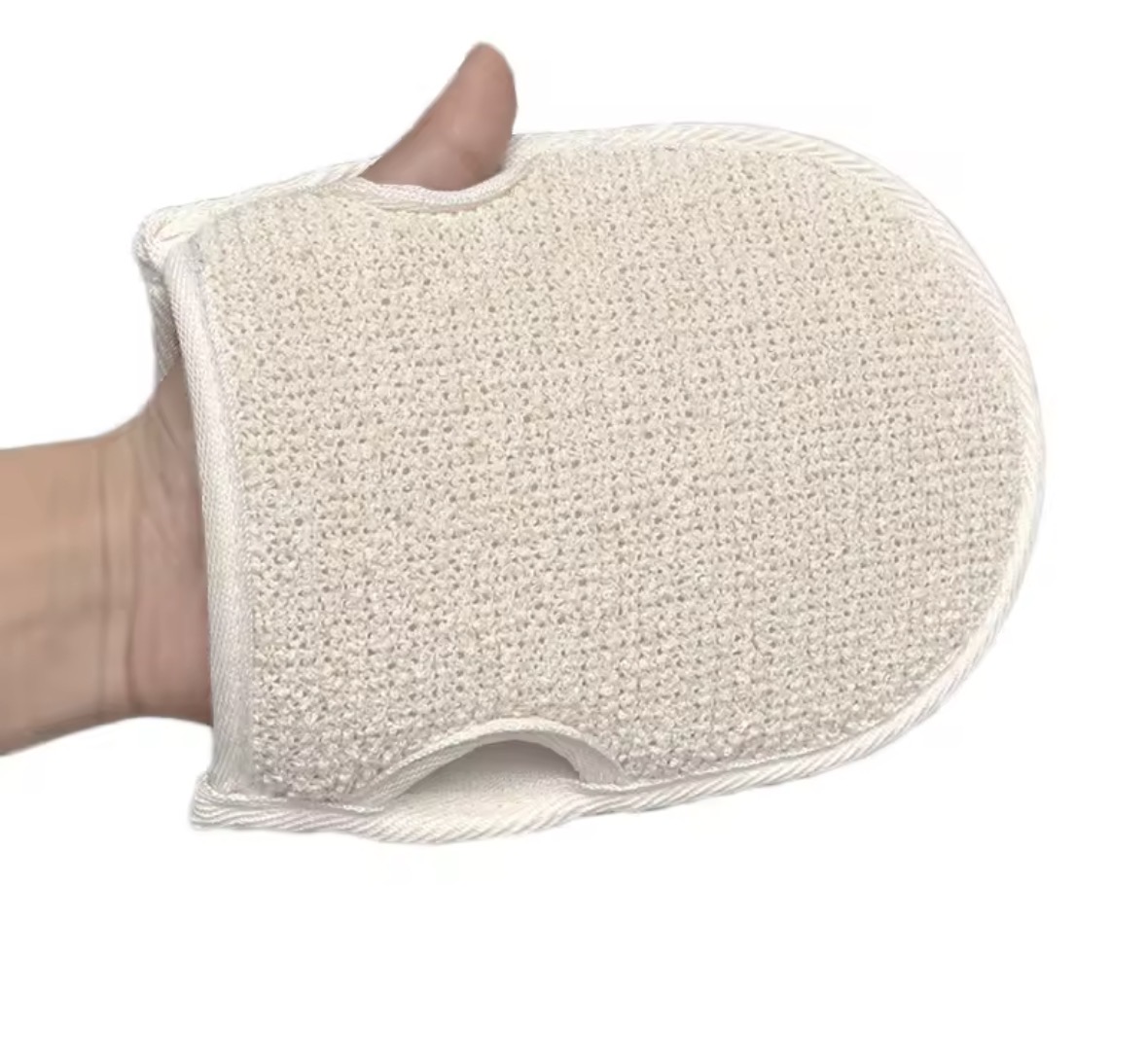 Natural woven loofah-fibre shower mitt held in a hand